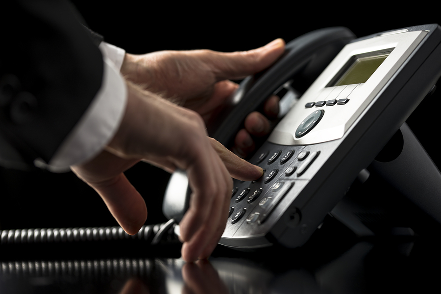 Businessman Dialling Out On A Telephone Call